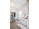 Bright kitchen showcasing stainless steel appliances, white cabinets, and modern fixtures at 702 S Government St, Lincolnton, NC 28092