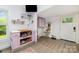 Eat-in kitchen shows pastel-colored cabinets, stainless appliances, wood-look flooring, and storage at 702 S Government St, Lincolnton, NC 28092