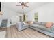 Open living room showcases wood-look floors, recessed lighting, and stairs to the left of the room at 702 S Government St, Lincolnton, NC 28092