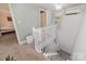 Bright, carpeted staircase featuring a white handrail and access to a bedroom, enhancing the home's airy feel at 702 S Government St, Lincolnton, NC 28092