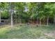 Grassy backyard with a wooden swing and cozy seating area at 812 Thornapple Ct, Lake Wylie, SC 29710