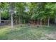 Grassy backyard with a wooden swing and cozy seating area at 812 Thornapple Ct, Lake Wylie, SC 29710