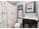 Charming bathroom with a nautical-themed shower curtain and a dark wood vanity at 812 Thornapple Ct, Lake Wylie, SC 29710
