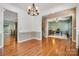 Inviting dining room featuring hardwood floors and a modern chandelier, perfect for entertaining guests and Gathering at 812 Thornapple Ct, Lake Wylie, SC 29710