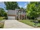 Inviting front exterior of home with an attached garage, a front porch, and meticulous landscaping at 812 Thornapple Ct, Lake Wylie, SC 29710