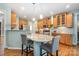 Kitchen with hardwood floors, granite countertops, stainless appliances, and a breakfast bar with comfortable seating at 812 Thornapple Ct, Lake Wylie, SC 29710