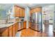 Bright kitchen features stainless steel appliances, granite countertops, hardwood floors and ample cabinet space at 812 Thornapple Ct, Lake Wylie, SC 29710