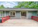 Backyard deck with a red railing along the back of a house with a large sliding glass door at 9021 Louvaine Dr, Charlotte, NC 28227