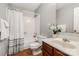 Bathroom featuring a shower-tub combination, single sink vanity, and decorative accents at 9021 Louvaine Dr, Charlotte, NC 28227