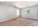 Bedroom with carpeted floors, neutral walls, and a ceiling fan for added comfort at 9021 Louvaine Dr, Charlotte, NC 28227