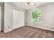 Bedroom featuring a fan, carpet flooring, a closet, and a window offering an outdoor view at 9021 Louvaine Dr, Charlotte, NC 28227
