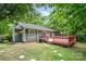 Exterior view of the home showcasing a wood deck, siding and landscaping at 9021 Louvaine Dr, Charlotte, NC 28227