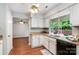 Cozy kitchen with wood countertops, modern appliances, and a view of the outdoor greenery and living room at 9021 Louvaine Dr, Charlotte, NC 28227