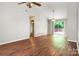 Open living room with wood floors, fan, and sliding glass door to a deck at 9021 Louvaine Dr, Charlotte, NC 28227