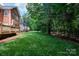 Expansive backyard with mature trees, and lush green lawn providing privacy at 905 Patricians Ln, Monroe, NC 28110