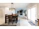 Dining area with a view to a living room with fireplace and large windows for bright, natural light at 905 Patricians Ln, Monroe, NC 28110
