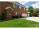 Brick home with a three-car garage and well-maintained lawn at 905 Patricians Ln, Monroe, NC 28110