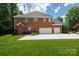 Brick home with a three-car garage and well-maintained lawn at 905 Patricians Ln, Monroe, NC 28110