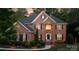 Stunning brick home with manicured lawn, black shutters, and warm lighting at 905 Patricians Ln, Monroe, NC 28110