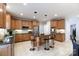 Spacious kitchen featuring stainless steel appliances, dark countertops, and an island with barstools at 905 Patricians Ln, Monroe, NC 28110