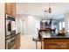 Modern kitchen showcasing stainless appliances and island with seating with view to dining and living rooms at 905 Patricians Ln, Monroe, NC 28110