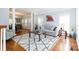 Bright living room with hardwood floors, decorative columns, and a gray sofa with throw pillows at 905 Patricians Ln, Monroe, NC 28110