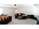 Spacious living room with large sofa, floral ottoman, and media center with an abundance of natural light at 905 Patricians Ln, Monroe, NC 28110