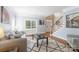 Bright living room showcasing stylish furniture, large windows, and hardwood floors with staircase at 905 Patricians Ln, Monroe, NC 28110
