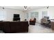 Open living room featuring a large sofa, chair, ceiling fan, media center and desk area with lots of natural light at 905 Patricians Ln, Monroe, NC 28110