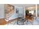 View of open floor plan living room with staircase, columns, and dining area beyond at 905 Patricians Ln, Monroe, NC 28110