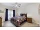 Cozy bedroom with patterned bedding, side tables and ample natural light at 905 Patricians Ln, Monroe, NC 28110
