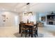 Open concept dining area features modern lighting and view to the living room with fireplace at 905 Patricians Ln, Monroe, NC 28110