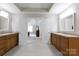 Bright and airy main bathroom featuring double vanities and an open doorway to the main bedroom at 905 Patricians Ln, Monroe, NC 28110