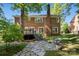 The rear of the brick house highlights a stone pathway, elevated deck, and mature trees at 909 Staghorn Ln, Waxhaw, NC 28173