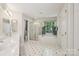 Bright bathroom featuring a double sink vanity, separate shower, and soaking tub at 909 Staghorn Ln, Waxhaw, NC 28173