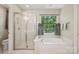 Bathroom with a soaking tub situated under a window and a separate shower stall at 909 Staghorn Ln, Waxhaw, NC 28173