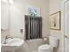 Cozy half bathroom features pedestal sink, toilet, and framed window at 909 Staghorn Ln, Waxhaw, NC 28173