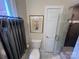 Neutral half bathroom features toilet and glass shower with neutral tiles at 909 Staghorn Ln, Waxhaw, NC 28173