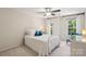 Bright bedroom with a ceiling fan, side table, and bright windows, offering a relaxing and comfortable space at 909 Staghorn Ln, Waxhaw, NC 28173