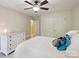 Bright bedroom with a ceiling fan, side table, and large closet, offering a comfortable and functional space at 909 Staghorn Ln, Waxhaw, NC 28173