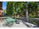 Relaxing backyard deck surrounded by lush, mature trees. Features dining and sitting areas at 909 Staghorn Ln, Waxhaw, NC 28173