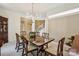 Formal dining room with a chandelier, classic table with seating for six, and natural light at 909 Staghorn Ln, Waxhaw, NC 28173