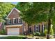 Lovely two-story brick home featuring mature trees, manicured lawn and a 2 car garage at 909 Staghorn Ln, Waxhaw, NC 28173
