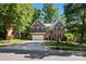 Stately two-story brick home featuring a two-car garage and mature landscaping on a sunny day at 909 Staghorn Ln, Waxhaw, NC 28173