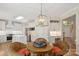 Bright eat-in kitchen features white cabinets, stainless appliances, and a wooden dining table at 909 Staghorn Ln, Waxhaw, NC 28173