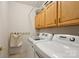 Practical laundry room with a washer, dryer, and storage cabinets at 909 Staghorn Ln, Waxhaw, NC 28173