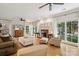 Bright living room featuring hardwood floors, fireplace, neutral paint, and an abundance of natural light at 909 Staghorn Ln, Waxhaw, NC 28173