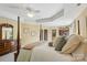 The cozy main bedroom features soft textures and a sunny ensuite bathroom at 909 Staghorn Ln, Waxhaw, NC 28173