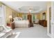 Spacious main bedroom with tray ceiling, natural light, and classic furnishings at 909 Staghorn Ln, Waxhaw, NC 28173
