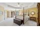 This main bedroom boasts a tray ceiling, natural light, and elegant decor at 909 Staghorn Ln, Waxhaw, NC 28173